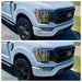 Two views of a white Ford truck with a focus on the front grille BEFORE AND AFTER