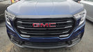 Front view of a blue GMC vehicle with a clear background