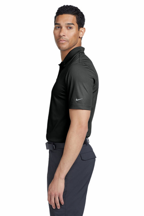 Man wearing a black polo shirt with a TI Holdings logo on a white background