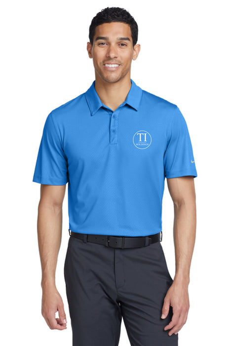 Man wearing a blue polo shirt with a TI Holdings logo on a white background