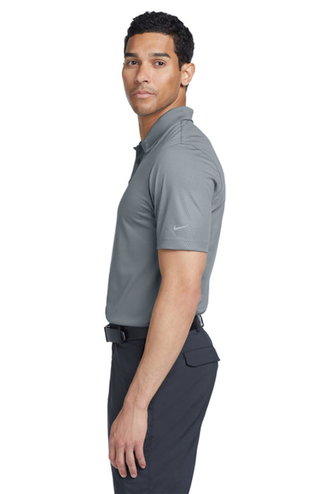 Man wearing a gray polo shirt on a white background