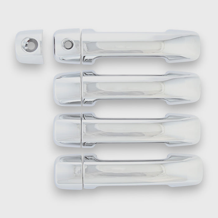 Set of chrome car door handles on a white background