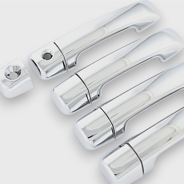 Set of chrome car door handles on a white background