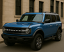 Blue Ford Bronco with chrome door handles installed