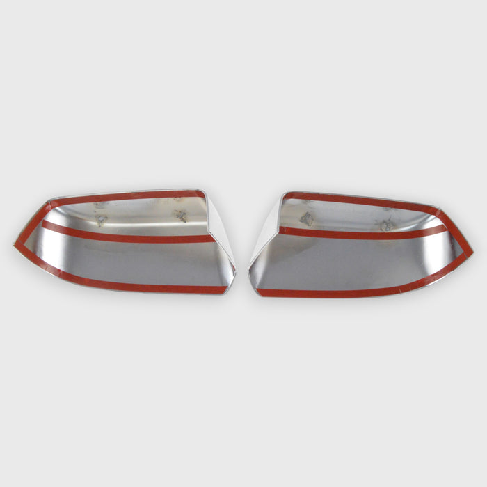 Two chrome car mirrors with red trim on a white background