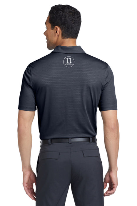 Man wearing a navy polo shirt with a TI Holdings logo on a white background