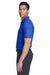 Man wearing a blue Nike Chrome Enhancments polo shirt and gray pants on a white background