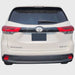 Back view of a white Toyota Highlander on a light gray background