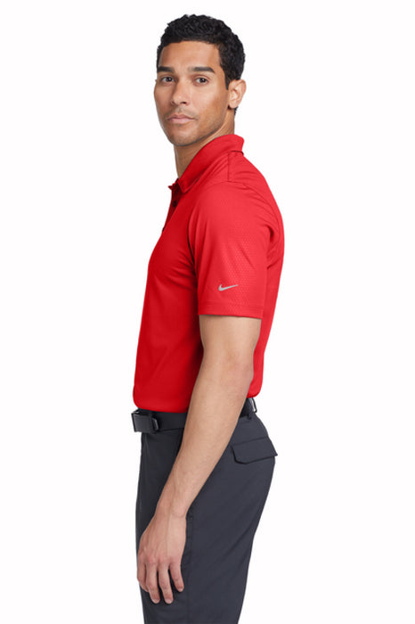 Man wearing a red Nike Chrome enhancements polo shirt and dark pants on a white background