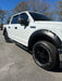White pickup truck with black wheel skins installed