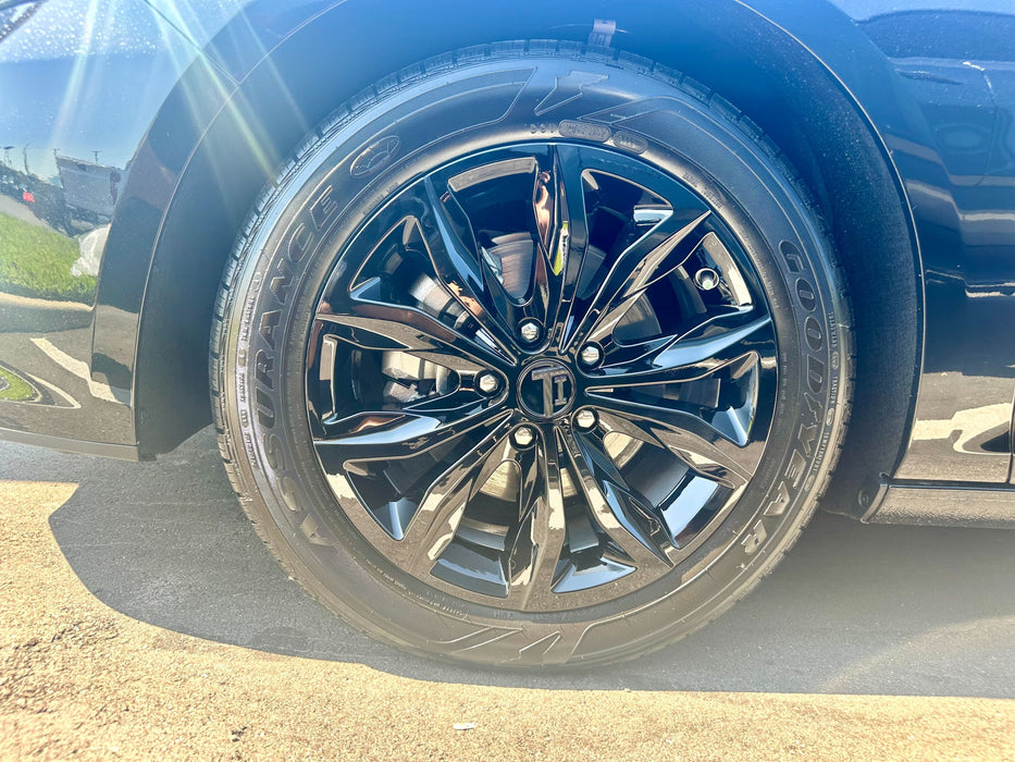 Close-up of a car wheel with chrome delete wheel skin installed