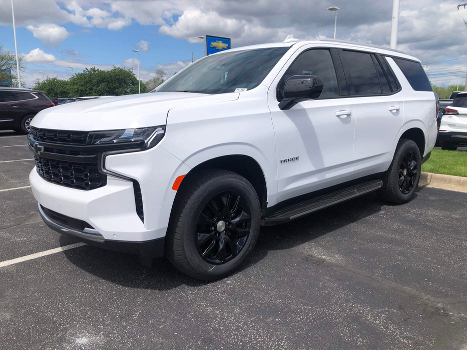 White SUV parked in a lot with a Chevrolet sign in the background