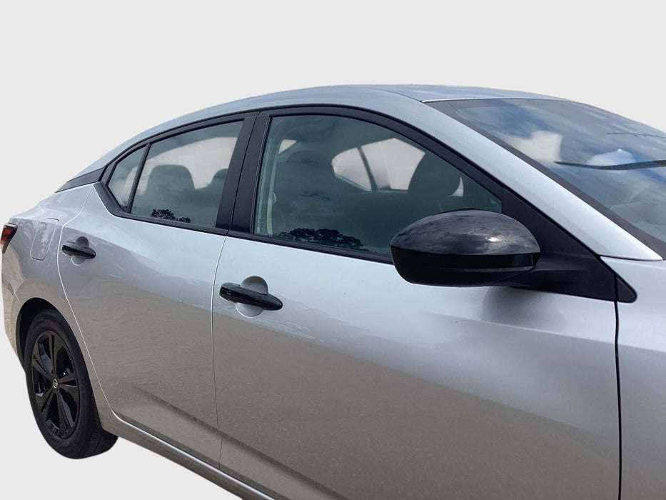 Side view of a silver car with chrome delete accessories