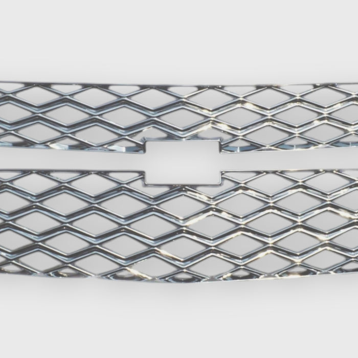 Close-up of a Chevrolet grille with diamond pattern on a white background