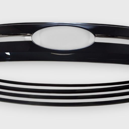 Close-up of a f150 chrome delete grille with a prominent emblem on a white background