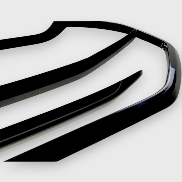 Close-up of a car grille with a chrome delete glossy finish on a white background