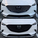 Comparison of a white Mazda car with and without a black grille chrome delete