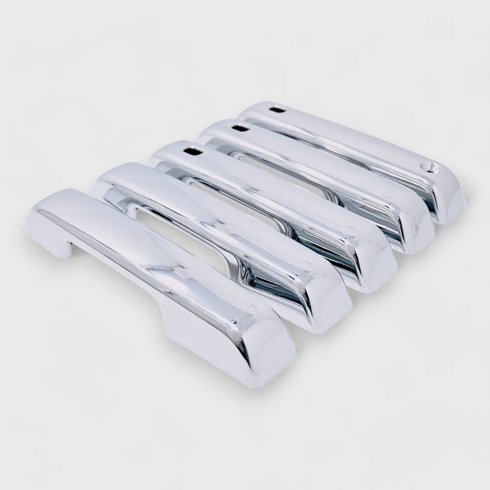 Set of chrome car door handles on a white background