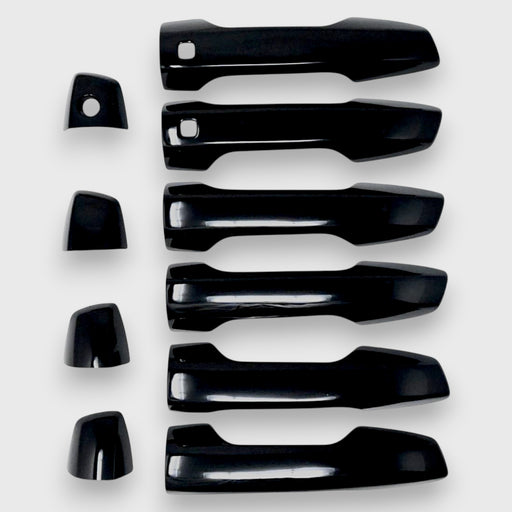 Set of black car door handles on a white background