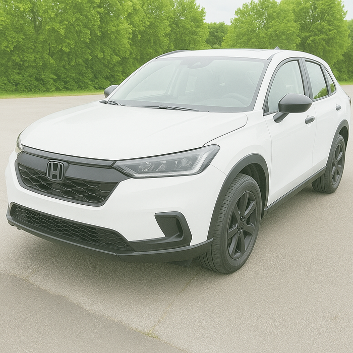 White Honda SUV on a road with green trees in the background with chrome delete installed