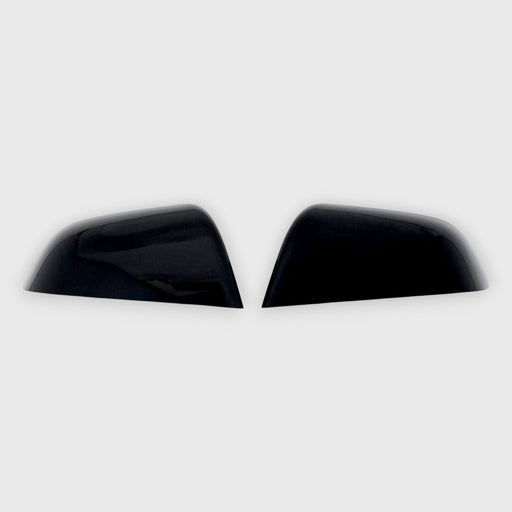 Two black car mirror covers on a white background