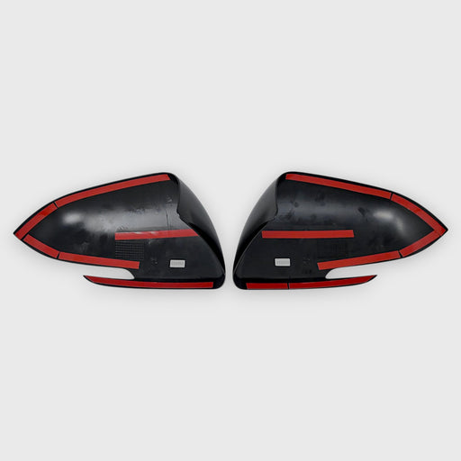 Two black car mirrors on a light gray background