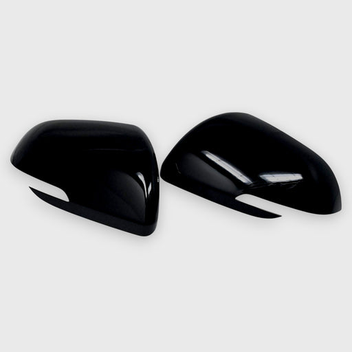 Two black car mirrors on a light gray background