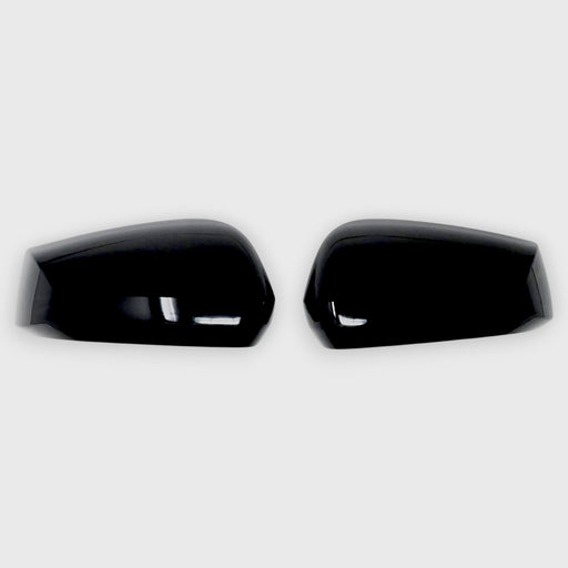Two black Kia Sportage car mirror covers on a white background