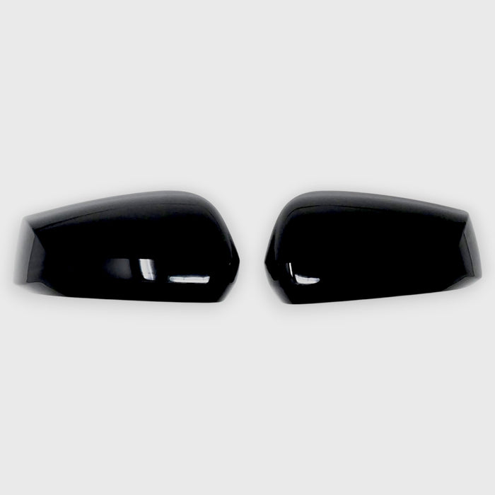 Two black Kia Sportage car mirror covers on a white background