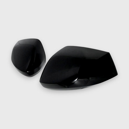 Two black Kia Sportage car mirror covers on a white background