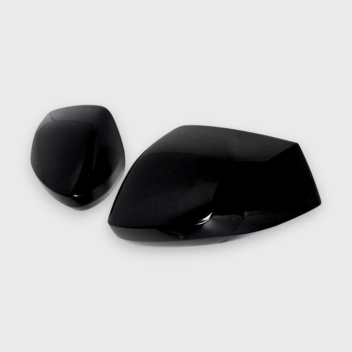 Two black Kia Sportage car mirror covers on a white background