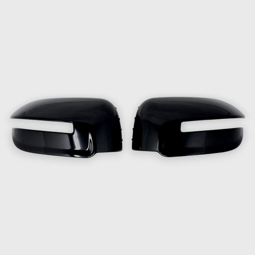 Black car mirror covers with white trim on a light gray background