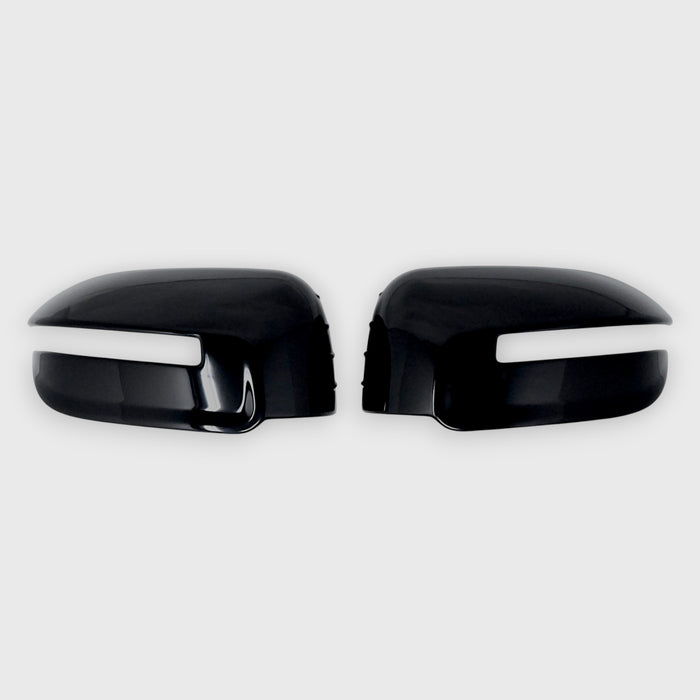 Black car mirror covers with white trim on a light gray background