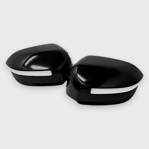 Black car mirror covers with white trim on a light gray background