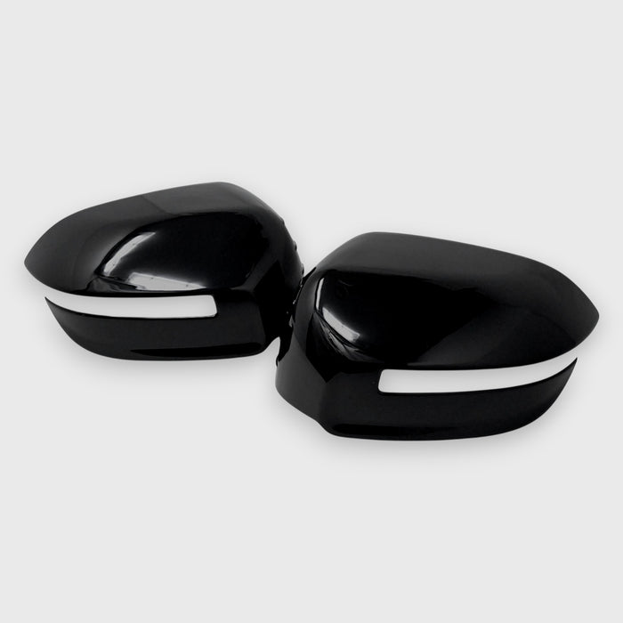 Black car mirror covers with white trim on a light gray background