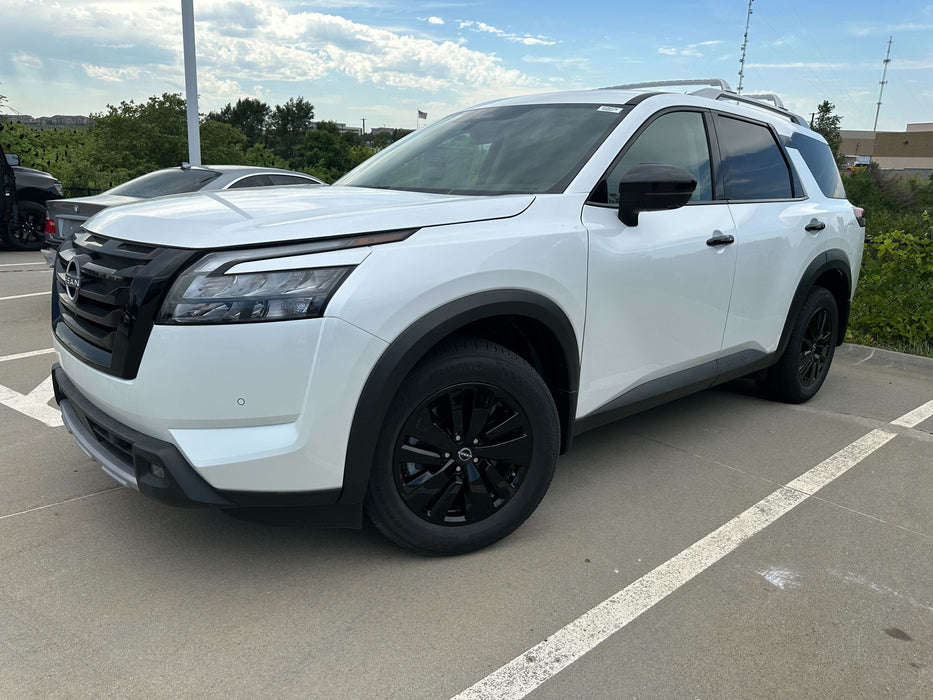 White SUV with black chrome delete wheel skins installed
